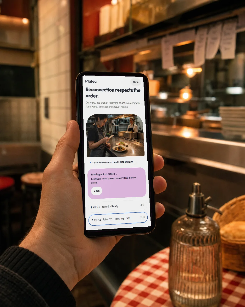 Platea on a phone at a restaurant table: the restaurant's own menu, mid-order